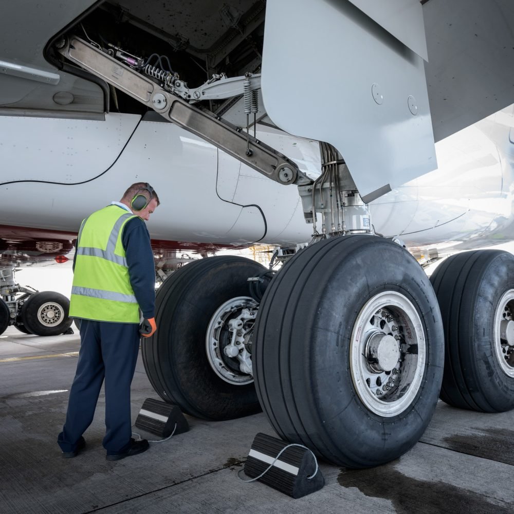 Engineer inspecting A380 aircraft at stand in airport